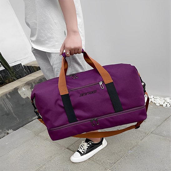 Sac de sport violet tenu dans une main